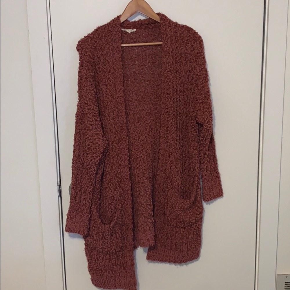 Reddish-pink sweater.